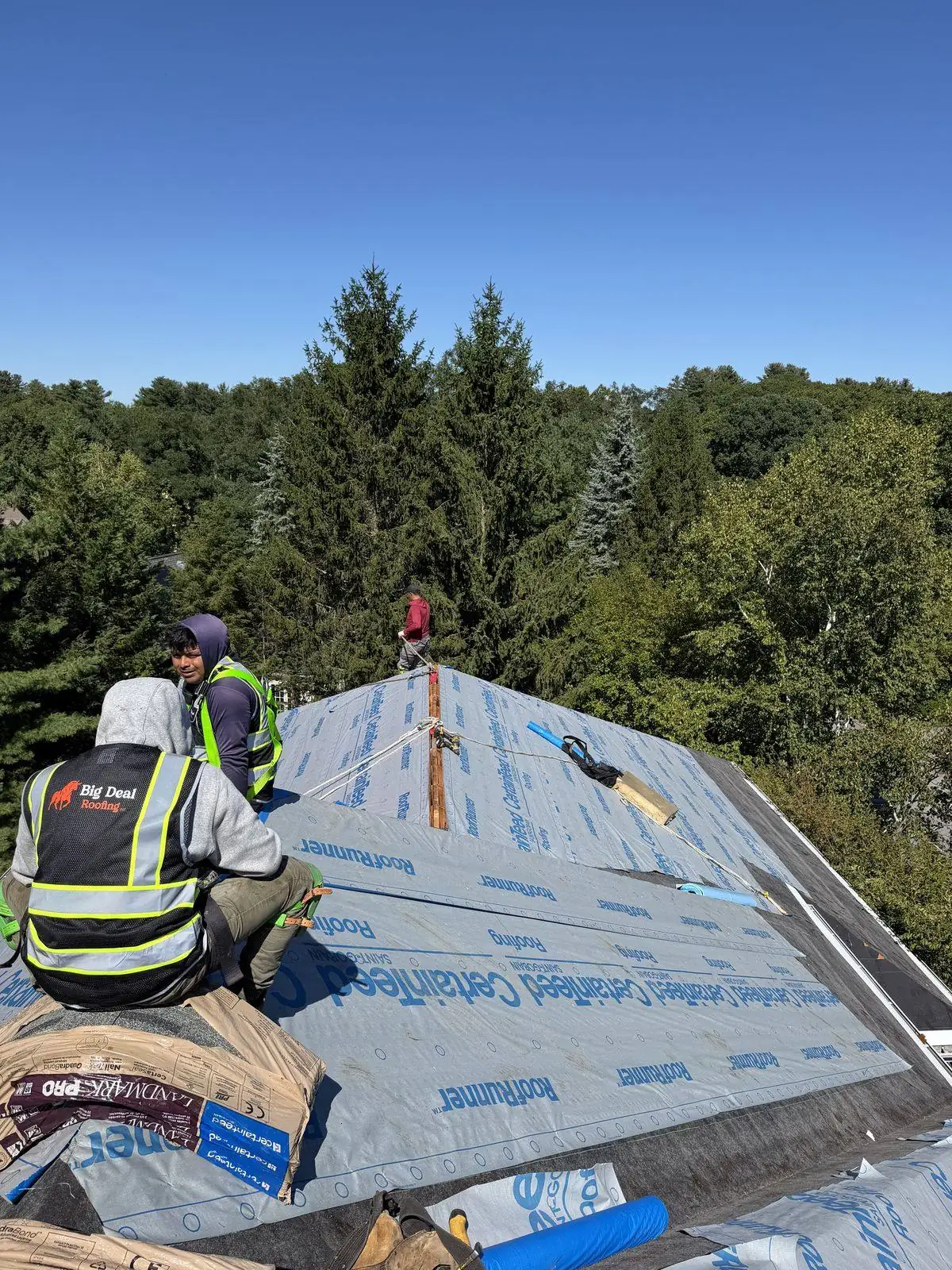 Crew installing CertainTeed underlayment